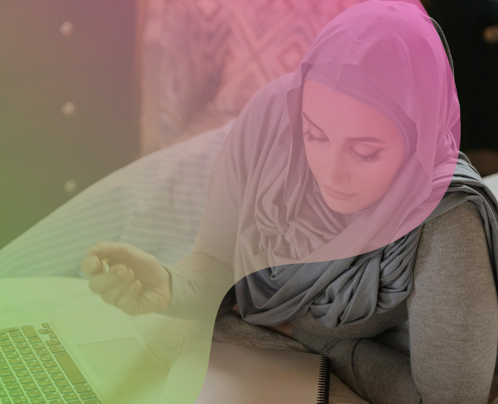 muslim woman with hijab working on the computer with pink and green filter